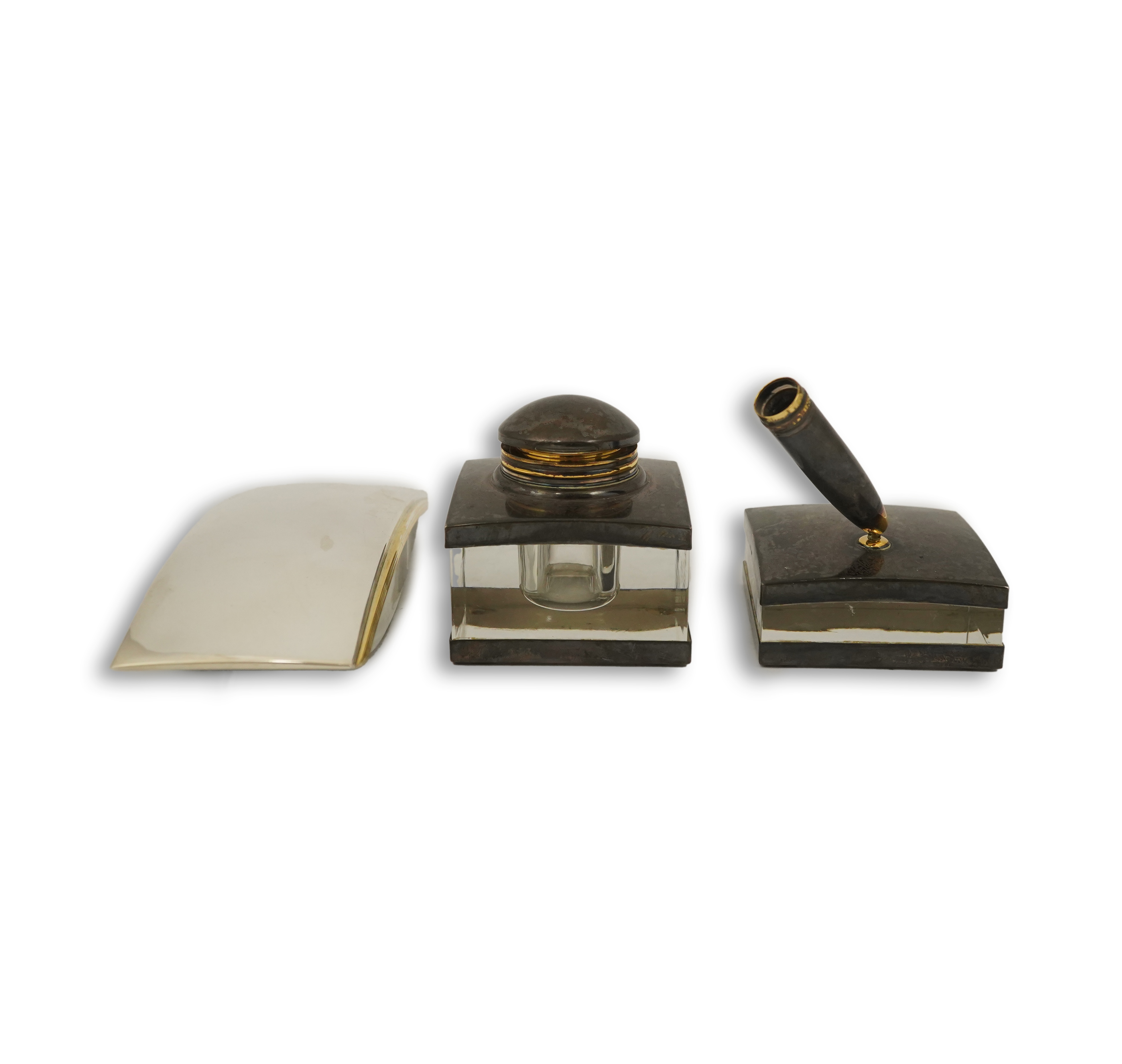 A Montblanc three piece German silver and glass desk set comprising pen stand, inkwell and blotter, each glass mounted, silver engraved with the Montblanc logo